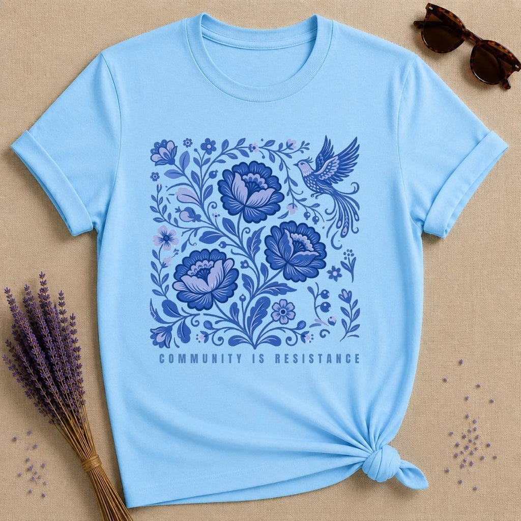 Community Is Resistance — Blue Floral Folk Art T-Shirt for Women in Sky