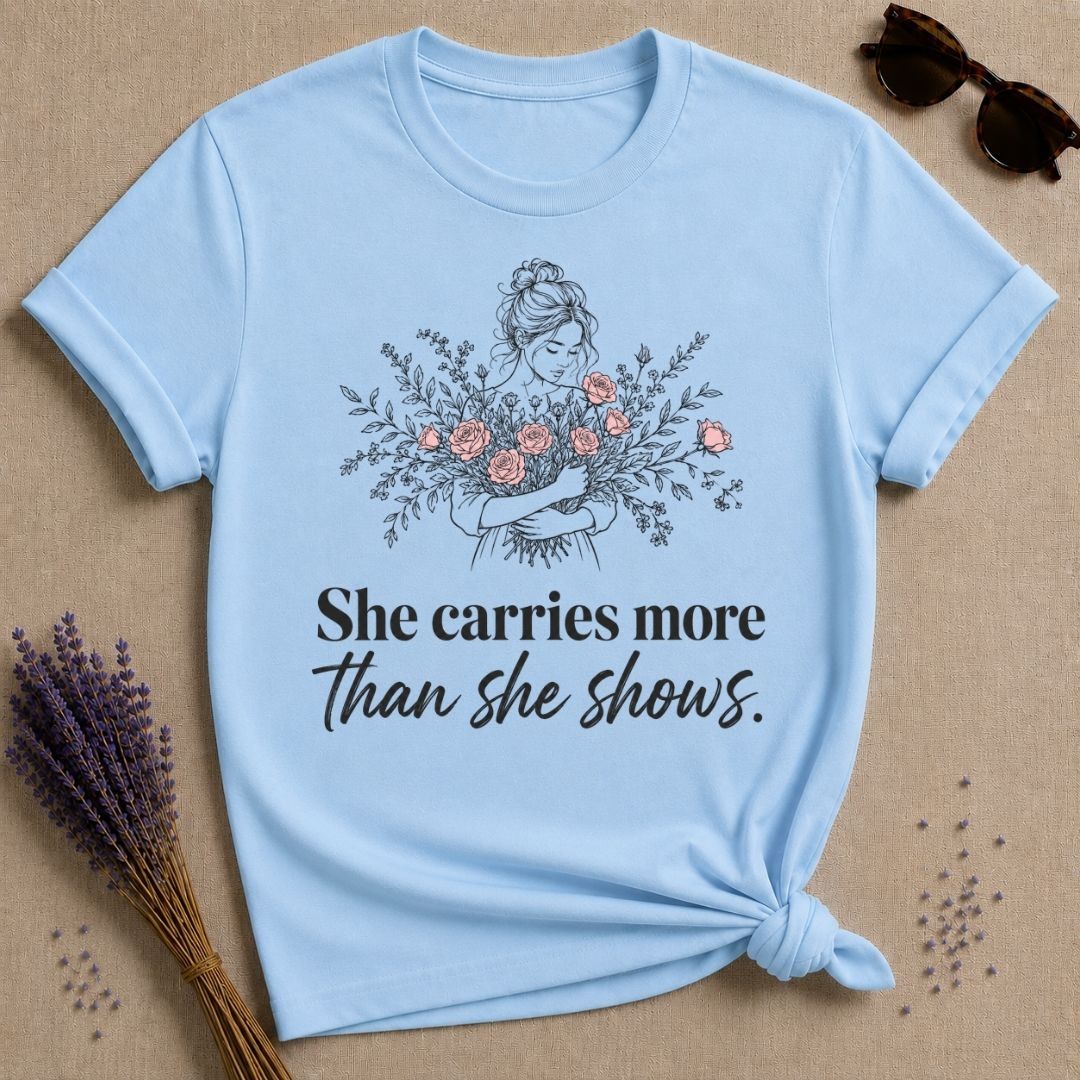 She Carries More Than She Shows botanical graphic tee for women
