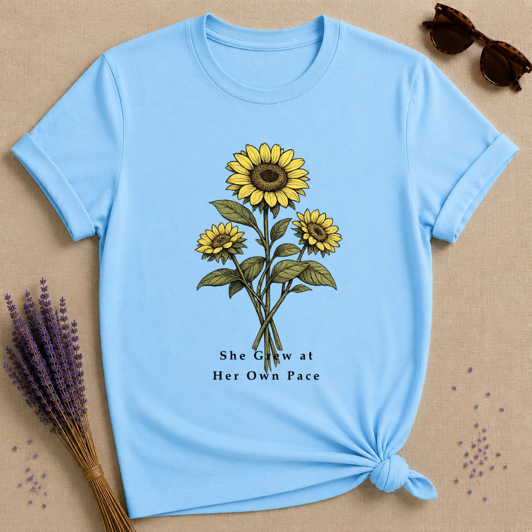 She Grew at Her Own Pace — Sunflower Self Growth T-Shirt for Women — Sky