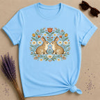 Two Rabbits in the Garden — Botanical Floral Wreath Graphic T-Shirt for Women in Sky